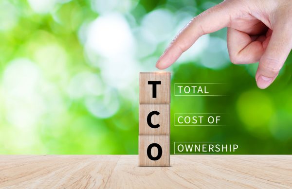 TCO concept. Total Cost of Ownership text on a wooden block, purchase price of an asset plus the costs of operation, business concept background