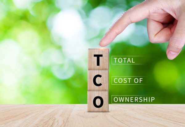 TCO concept. Total Cost of Ownership text on a wooden block, purchase price of an asset plus the costs of operation, business concept background